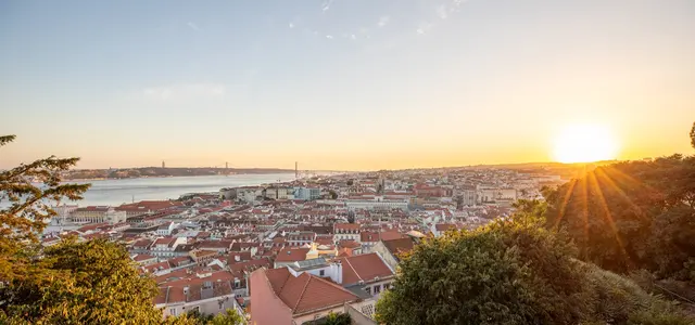 Lisbon rooftops glowing in warm evening light