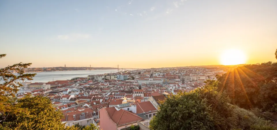 Lisbon rooftops glowing in warm evening light